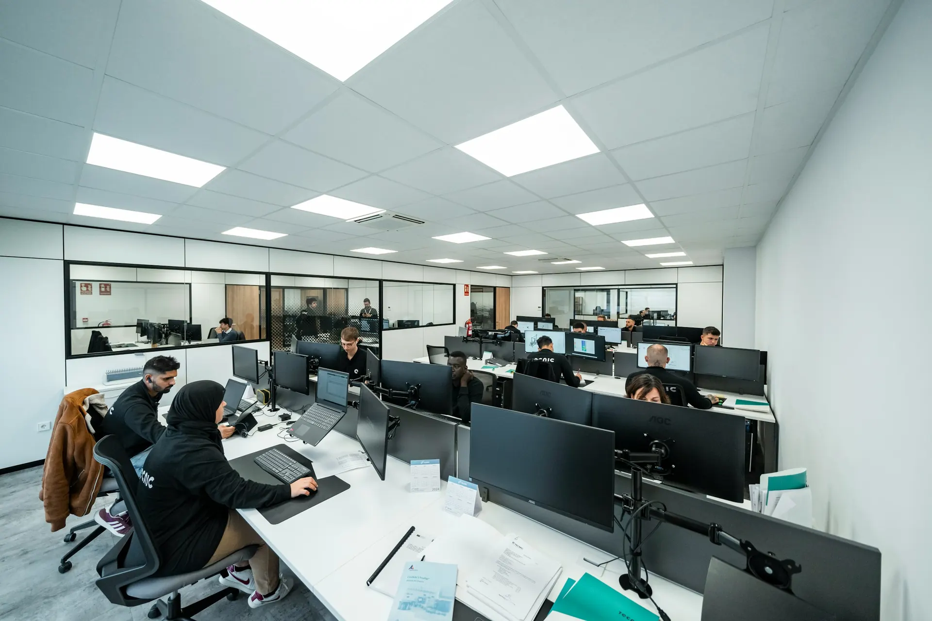 Office workers at computers in an open workspace