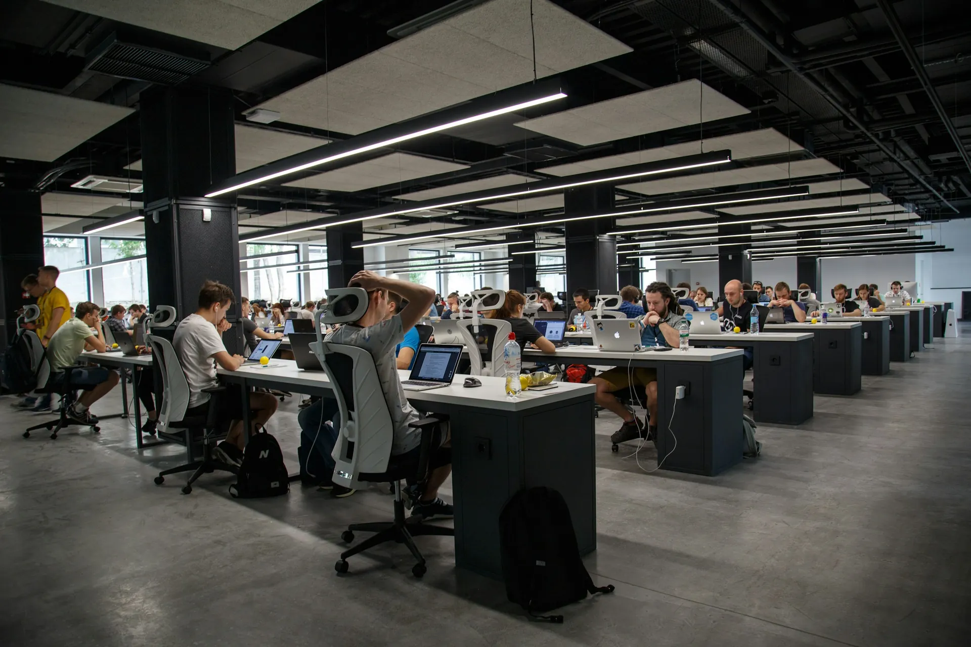 Open-plan technical office floor with rows of engineering workstations