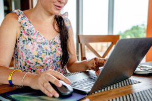 Remote virtual assistant working on a laptop, supporting architecture, engineering, and construction firms with administrative and project coordination tasks.