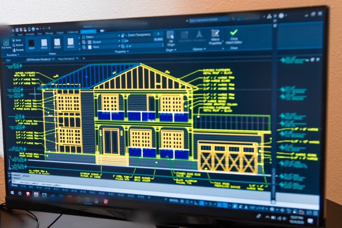 Detailed annotated building elevation drawing open in design software on a monitor